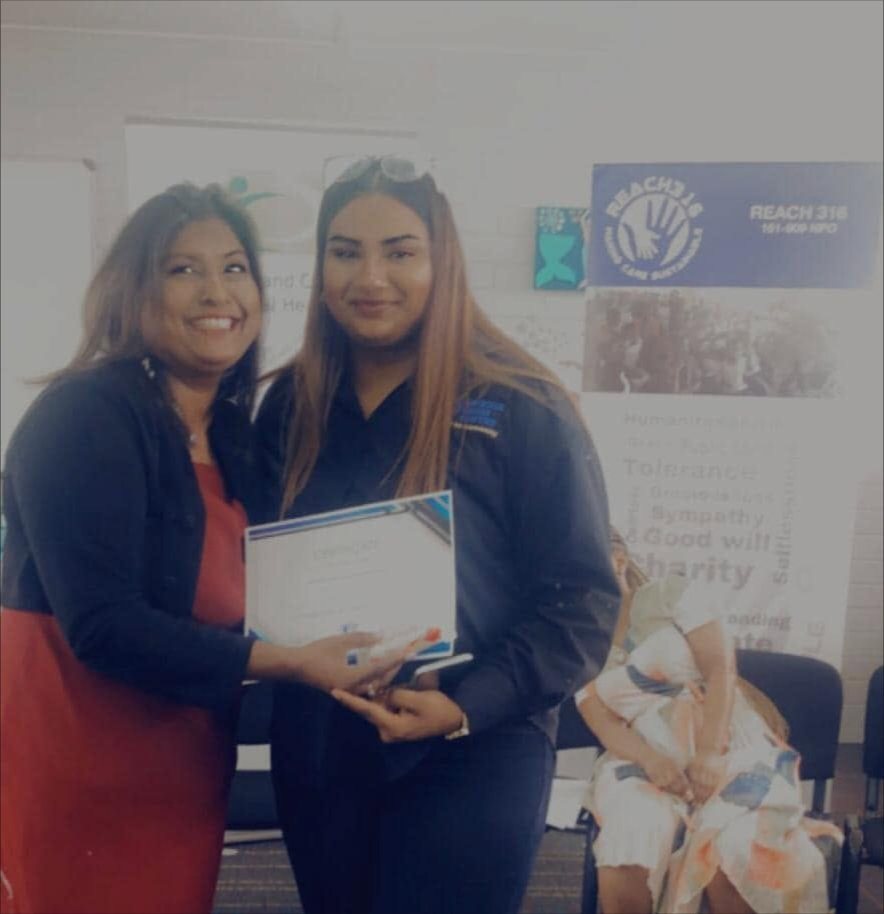 Two women at a certificate ceremony